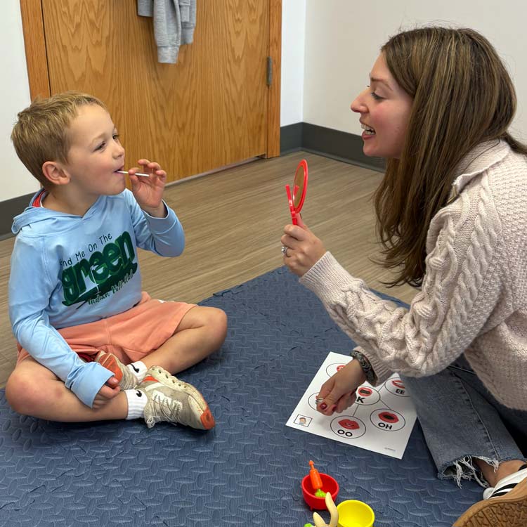Comprehensive SLP's Marci Barry working with a young client.
